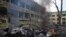 A car burns at the site of a maternity hospital heavily damaged by an airstrike, in Mariupol, Ukraine, March 9, 2022.