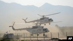 FILE - U.N. helicopters take part in a training session at a training base in central China's Henan province, Sept. 15, 2021.