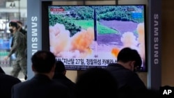 FILE - People watch a TV showing a file image of North Korea's missile launch during a news program at the Seoul Railway Station in Seoul, South Korea, March 5, 2022. (AP Photo /Ahn Young-joon)