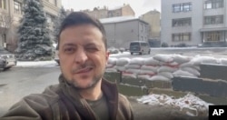 In this March 8, 2022, image from video provided by the Ukrainian Presidential Press Office and posted on Instagram, Ukrainian President Volodymyr Zelenskyy winks as he speaks in Kyiv, Ukraine. (Ukrainian Presidential Press Office via AP)