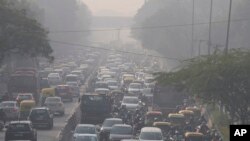 FILE - Commuters drive amidst morning haze and toxic smog in New Delhi, India, Wednesday, Nov. 17, 2021.