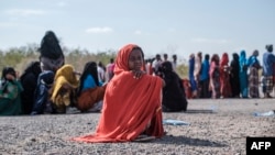 FILE - A girl sits as she waits in line with dozens of other internally displaced people to be registered by local authorities at a compound in Semera, Afar region, Ethiopia, Feb. 14, 2022. 