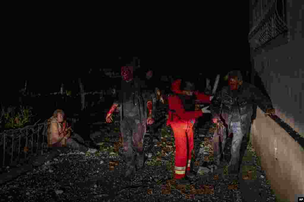 A paramedic helps an injured resident moments after a Russian strike in Kherson, southern Ukraine.