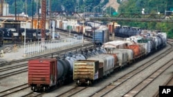 FILE - Freight cars wait to be hauled out of the Norfolk Southern Conway Terminal in Conway, Pennsylvania, Sept. 15, 2022. 