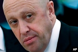 FILE - Russian businessman Yevgeny Prigozhin is shown prior to a meeting of Russian President Vladimir Putin and Chinese President Xi Jinping in the Kremlin in Moscow, Russia, July 4, 2017. The White House said Thursday that the Wagner Group, a private Russian military company, has taken delivery of an arms shipment from North Korea to help bolster its forces as it fights side-by-side with Russian forces in Ukraine. The U.S. assesses that Wagner, owned by Putin ally Yevgeny Prigozhin, is spending about $100 million a month in the fight. (Sergei Ilnitsky/Pool Photo via AP, File)