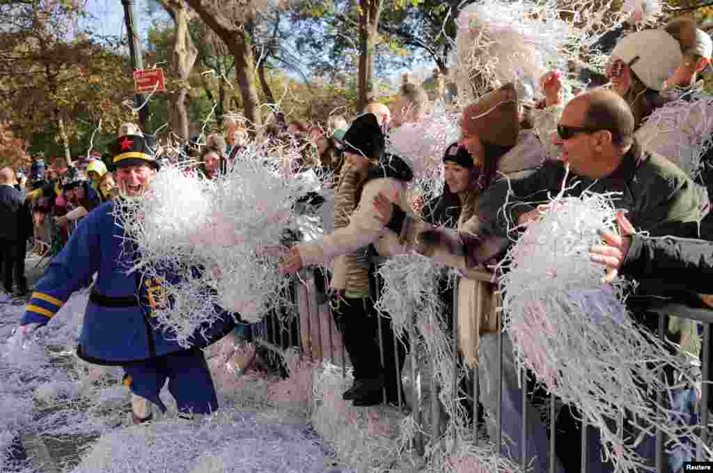 People attend the 96th Macy's Thanksgiving Day Parade in Manhattan, New York City.