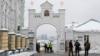 Ukrainian law enforcement officers stand next to an entrance to the Kyiv Pechersk Lavra monastery compound, amid Russia's attack on Ukraine, in Kyiv, Nov. 22, 2022. 