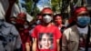 A protester wears a T-shirt depicting detained Myanmar civilian leader Aung San Suu Kyi during a demonstration outside the Embassy of Myanmar in Bangkok on Dec. 19, 2022