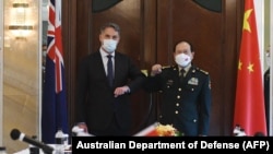 This handout photo taken and released on June 12, 2022 Australia's Defense Minister Richard Marles (L) meeting with China's Defense Minister Wei Fenghe on the sidelines of the Shangri-La Dialogue summit in Singapore.