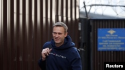 FILE - Russian opposition leader Alexei Navalny walks out of a detention center after he was jailed for 30 days for calling an unauthorized protest in Moscow, Aug. 23, 2019.