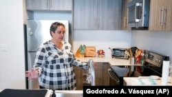 Lisa Raskin, a teacher at Jefferson Union High School District, talks in the kitchen of her new apartment, July 8, 2022.
