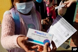 A second grade student is given a at-home COVID-19 test at H.W. Harkness Elementary School in Sacramento, Calif., on Feb. 11, 2022. (AP Photo/Rich Pedroncelli, File)