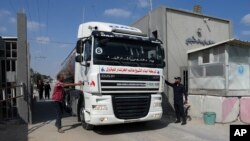 Hamas police officers check a tanker truck carrying fuel as it is cleared to enter the Palestinian side of the Kerem Shalom cargo crossing with Israel, in Rafah, southern Gaza Strip, Aug. 8, 2022. 