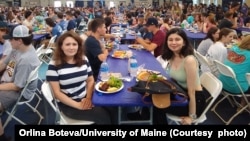 International students at the dinner with the university president during orientation at the University of Maine. 