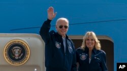 FILE - U.S. President Joe Biden waves as first lady Jill Biden watches standing at the top of the steps of Air Force One before boarding at Andrews Air Force Base, Md., Saturday, Sept. 17, 2022. (AP Photo/Gemunu Amarasinghe, File)