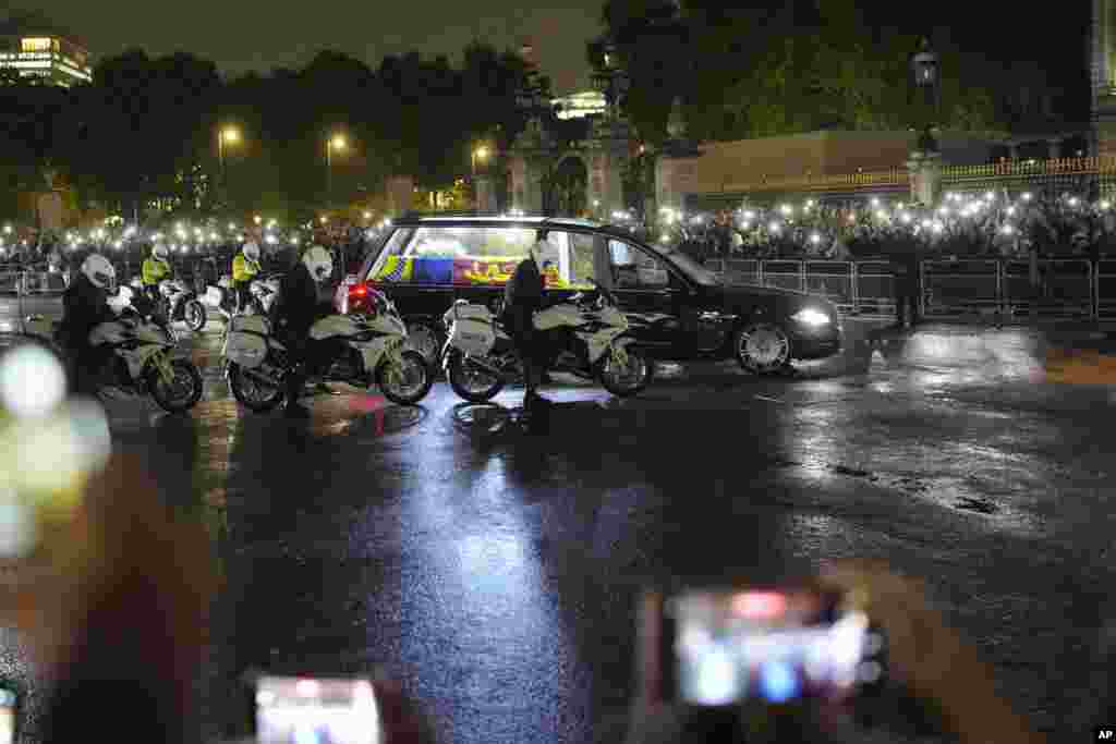 The hearse carrying Queen Elizabeth's coffin arrives at Buckingham Palace in London, Sept. 13, 2022.