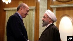 Turkey's President Recep Tayyip Erdogan, left, and Iran's President Hassan Rouhani greet each other before a meeting with Russia's President Vladimir Putin, in Sochi, Russia. Turkey and Iran recently signed an agreement with Qatar to ease some trade.