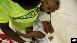 A baby stricken with cholera receives treatment at a clinic run by Doctors Without Borders in Port-au-Prince, Haiti, Friday, Nov. 11, 2022. (AP Photo/Odelyn Joseph)