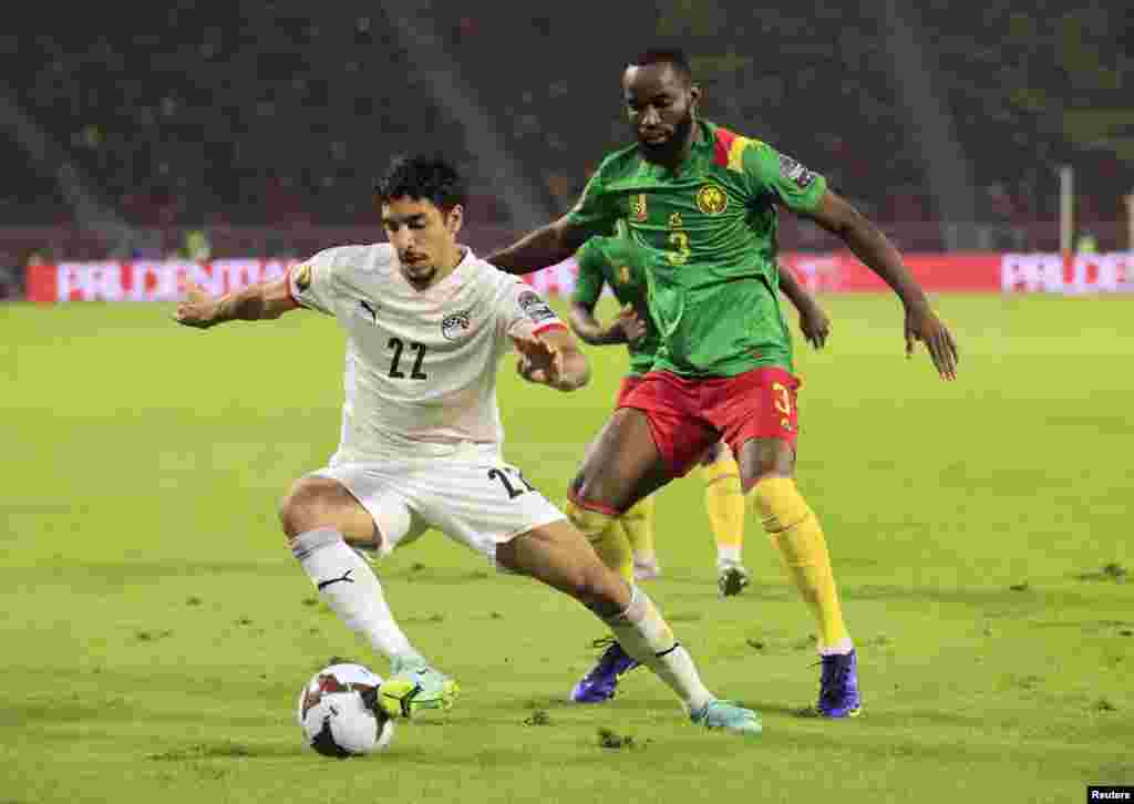 Egypt's Omar Marmoush in action with Cameroon's Nicolas Moumi Ngamaleu, Feb. 3, 2022.