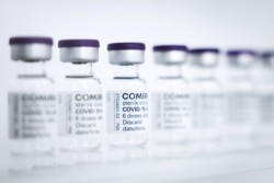 FILE - Empty vials to be filled with the Pfizer/BioNTech vaccine are seen at a production facility in Reinbek, near Hamburg, Germany, April 30, 2021.