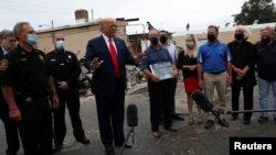 U.S. President Donald Trump speaks while viewing property damage during a visit in the aftermath of recent protests after the shooting of Jacob Blake by a police officer in Kenosha, Wisconsin, U.S., September 1, 2020. (REUTERS/Leah Millis)