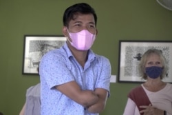 Block printing artist Morn Chear attends to visitors who come to support his exhibition in Phnom Penh, February 2022.