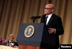 FILE - Then-President Barack Obama, left, listens to comedian Larry Wilmore at the White House Correspondents' Association annual dinner in Washington, April 30, 2016.