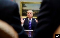 President Donald Trump speaks during a meeting with members of the House Ways and Means Committee in the Roosevelt Room of the White House, Sept. 26, 2017, in Washington. Trump says he'll visit hurricane-ravaged Puerto Rico next Tuesday.
