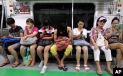 Most people do not talk to strangers while traveling on a subway.