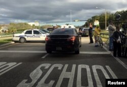 Police patrol the area outside Marjory Stoneman Douglas High School following a school shooting incident in Parkland, Florida, Feb. 15, 2018.