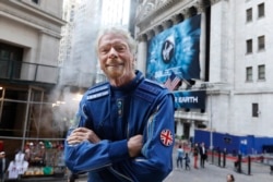 Sir Richard Branson, founder of Virgin Galactic, poses for a photo outside the New York Stock Exchange before his company's IPO, Monday, Oct. 28, 2019. (AP Photo/Richard Drew)