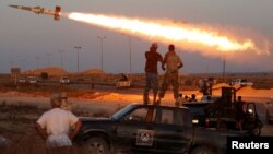 Fighters of Libyan forces allied with the U.N.-backed government fire a rocket at Islamic State fighters in Sirte, Libya, August 4, 2016.