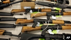 FILE - A cache of seized weapons is displayed in Phoenix, Jan 25, 2011.