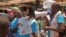 FILE - Health workers teach people about the Ebola virus and how to prevent infection in Conakry, Guinea, March 31, 2014. 