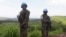 FILE - UN peacekeepers from Tanzania hold their weapons as they patrol outside Goma.