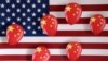 Illustration shows printed balloons with Chinese flag and U.S. flag
