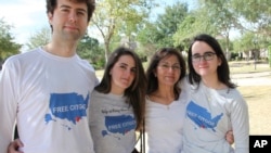 Wearing T-shirts with the message "Free the Citgo 6," the Vadell family poses for a photo in Katy, Texas, Feb. 15, 2019.