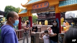 Residents wearing masks visit Yu Garden Mall, June 2, 2022, in Shanghai, the day after the easing of a strict two-month COVID-19 lockdown. 