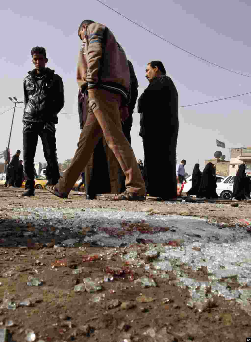 Broken glass remains at the scene of a suicide bomb attack at Adan Square, in a predominantly Shi'ite part of Baghdad, Feb. 9, 2015.