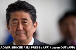 In this file photo taken on April 25, 2019 Japan's Prime Minister Shinzo Abe leaves the Bratislava Castle after a Visegrad group countries (V4) and Japan meeting in Bratislava. (Photo by VLADIMIR SIMICEK / JIJI PRESS / AFP)