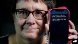 Chelle Wyatt uses her cell phone with the Otter app Friday, April 15, 2022, in Salt Lake City. (AP Photo/Rick Bowmer)
