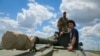 Ukrainian soldiers ride a self-propelled artillery vehicle Gvozdika in the Donetsk region, Ukraine, June 17, 2022.
