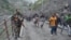 An Indian security guard keeps vigil as pilgrims cross mountain trails during their journey to the holy Amarnath cave in India. (Photo by Wasim Nabi)