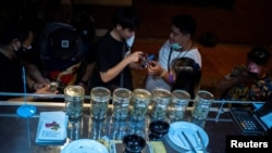 Customers queue to buy cannabis at the Happy Bud, a cannabis truck at Khaosan Road, one of the favourite tourist spots in Bangkok, Thailand, after it was removed from the narcotics list under Thai law, June 13, 2022.