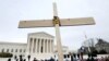 FILE - Anti-abortion activists hold a cross in front of the U.S. Supreme Court building during the annual "March for Life" in Washington, U.S., January 21, 2022. (REUTERS/Jim Bourg/File Photo)