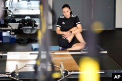 Yoshimi Yamashita of Japan, one of three women picked to be head referees at the men's soccer World Cup, works out at a gym, June 27, 2022, at JFA YUME Field in Chiba, near Tokyo.
