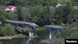FILE - A view of the destroyed bridge linking Sievierodonetsk with Lysychansk, during the Ukraine-Russia conflict, as seen from Lysychansk, in the Luhansk region, Ukraine, July 4, 2022.