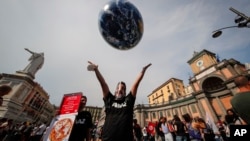 In this Thursday, July 22, 2021 file photo, people demonstrate on the sidelines of a G20 environment meeting, in Naples, Italy. (AP Photo/Salvatore Laporta, File)