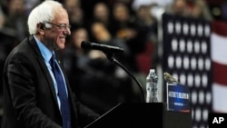 Democratic presidential candidate Bernie Sanders smiles as a bird lands on his podium when he addresses the crowd during a rally at the Moda Center in Portland, Ore., Friday, March 25, 2016. (AP Photo/Steve Dykes)