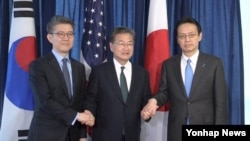 FILE - South Korea's Special Representative Kim Hong-kyun, U.S. State Department's Special Representative Joseph Yun and Japanese Director-General Kenji Kanasugi pose for a photo after their meeting at the US State Department on Feb. 27, 2017.